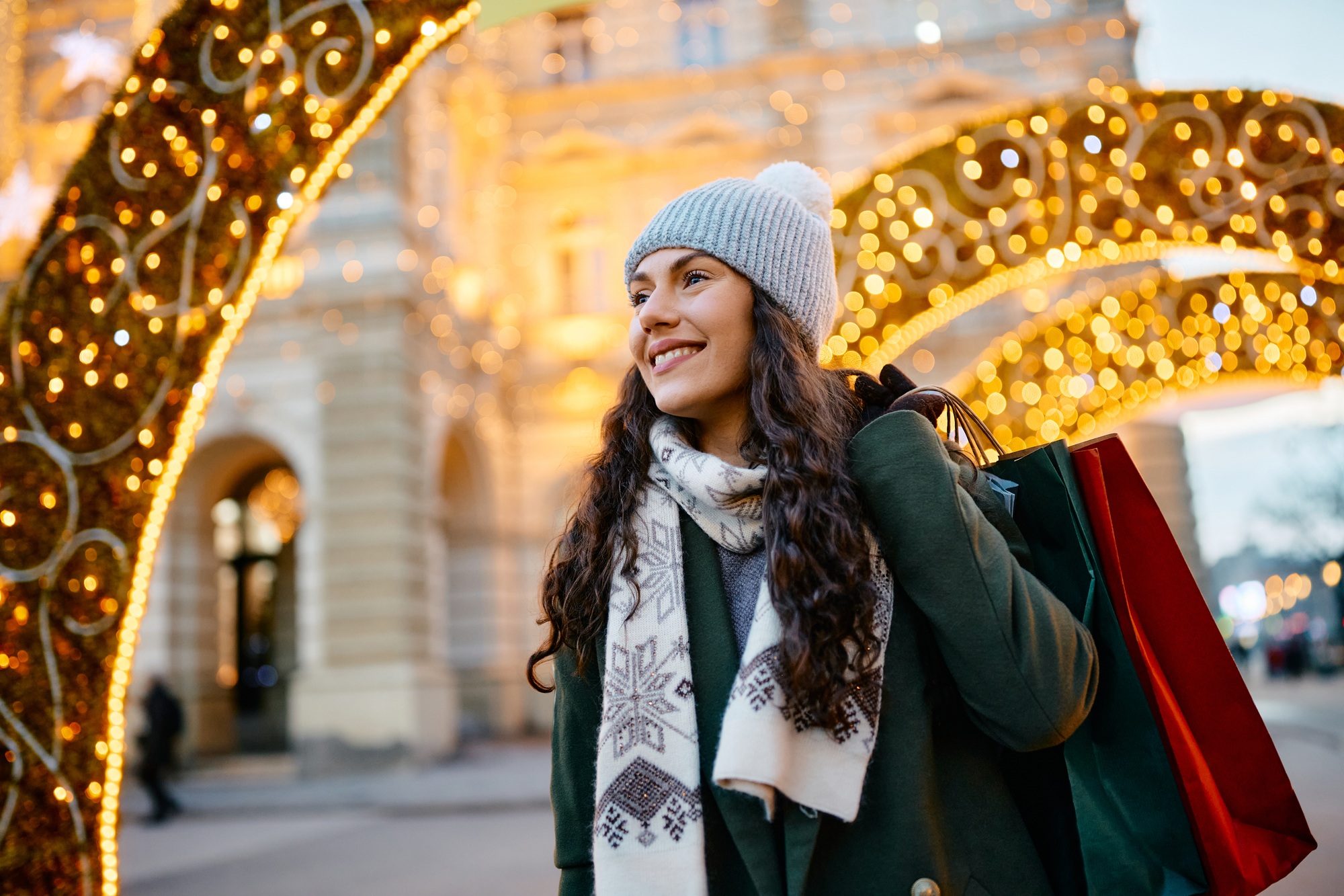 Beautiful woman enjoying in Christmas shopping during winter day.