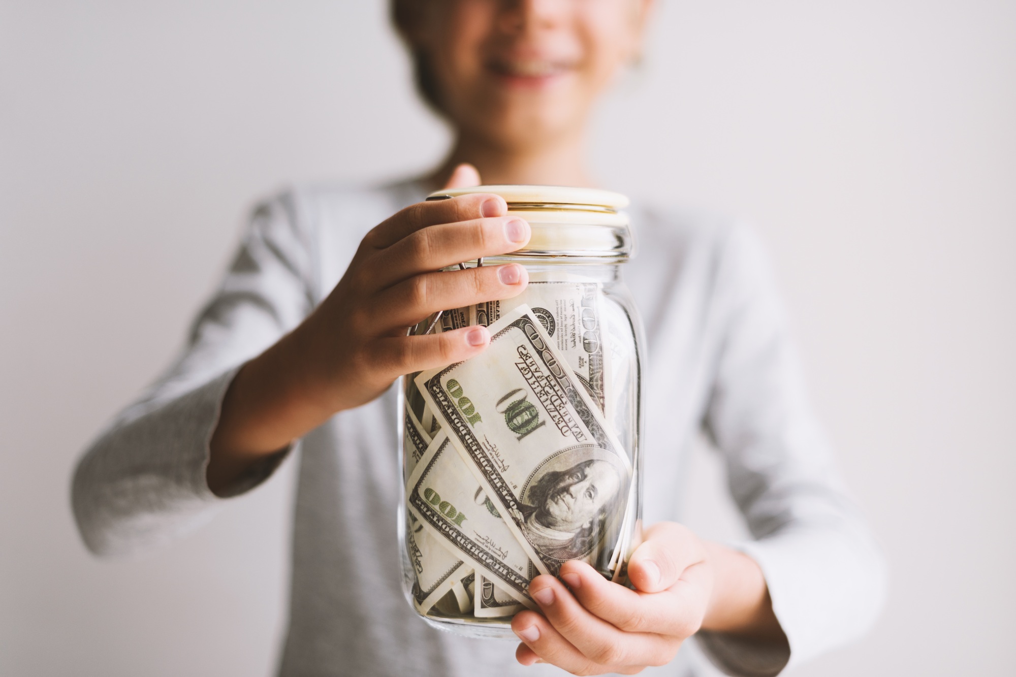 Kid save money. Put money in a piggy bank